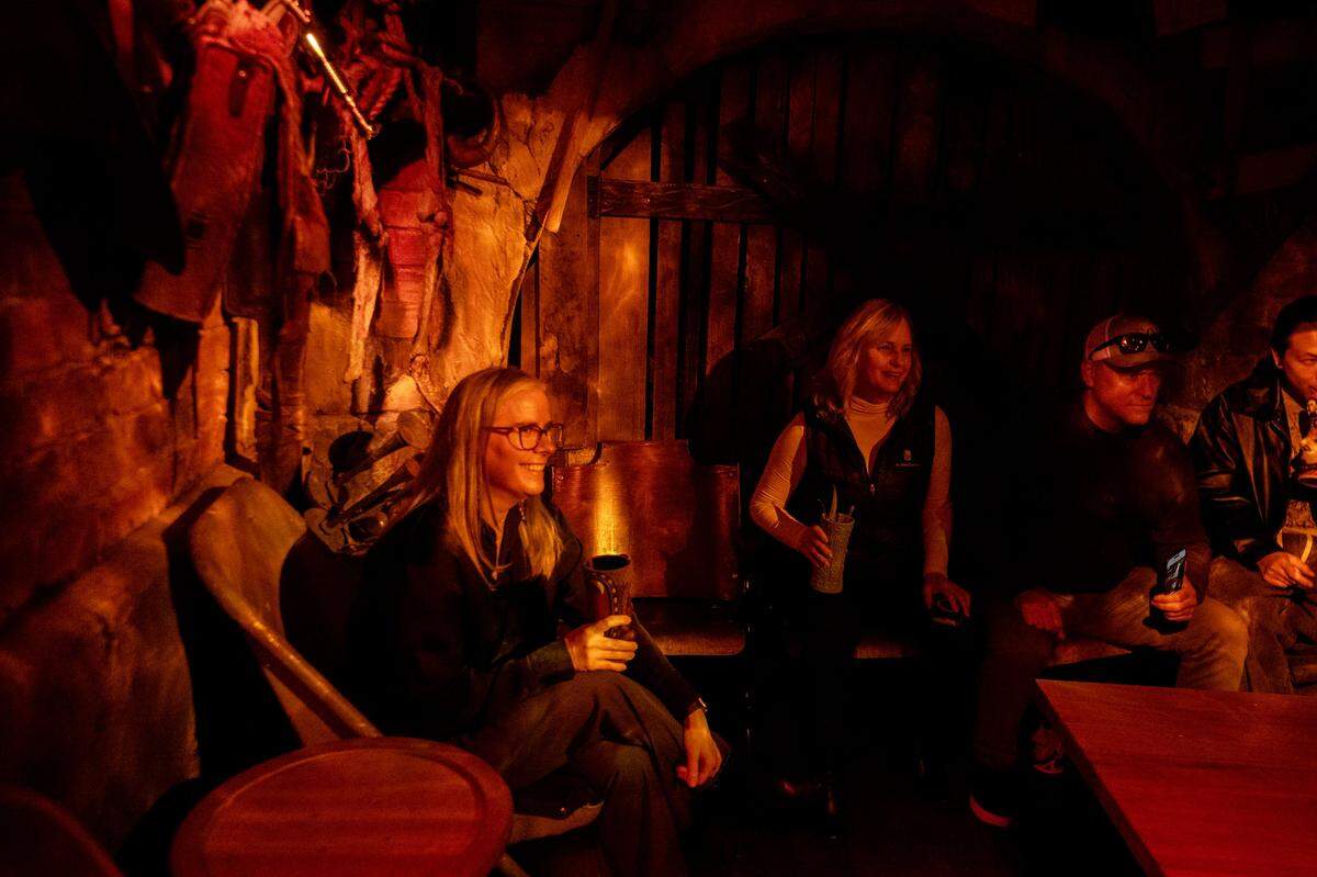 Megan Van Voorhis, left, Traci Rockefeller Cusack and Gary Gelfold visit at Hawthorne’s Hideout, a Tiki-themed underground speakeasy in Old Sacramento on Thursday.