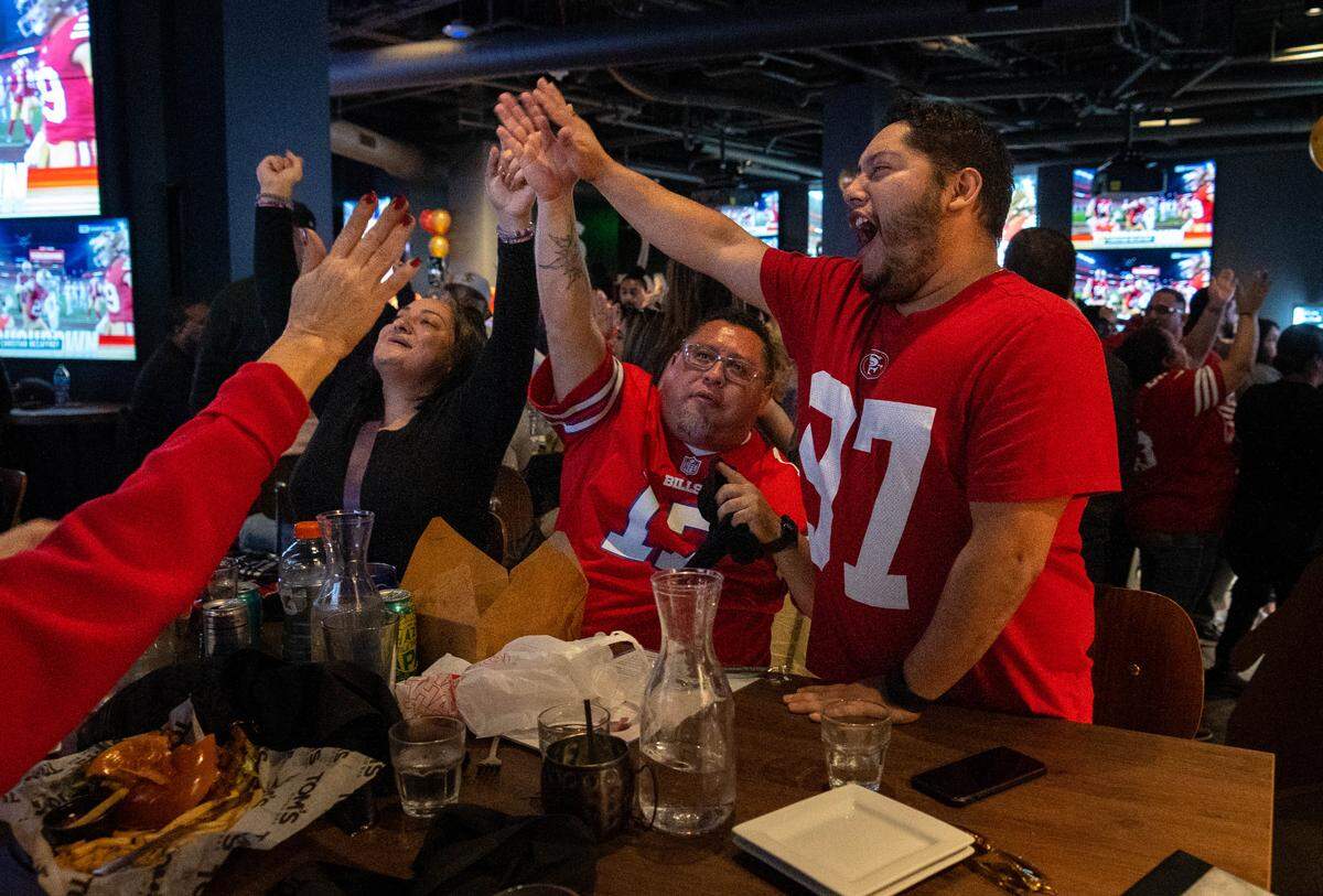 Demetrias Perdomo of Vacaville, right, celebrates a 49ers touchdown during the NFC Championship game watch party at Tom’s Watch Bar on Sunday, Jan. 28, 2024. The Downtown Commons bar will host a Super Bowl LX party on Sunday, Feb. 8, 2026.