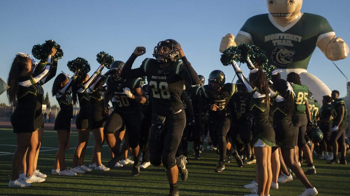 The Monterey Trail Mustangs run onto the field before Friday night’s game between the Monterey Trail Mustangs and Cosumnes Oaks Wolfpack in Elk Grove, September 7, 2018. 