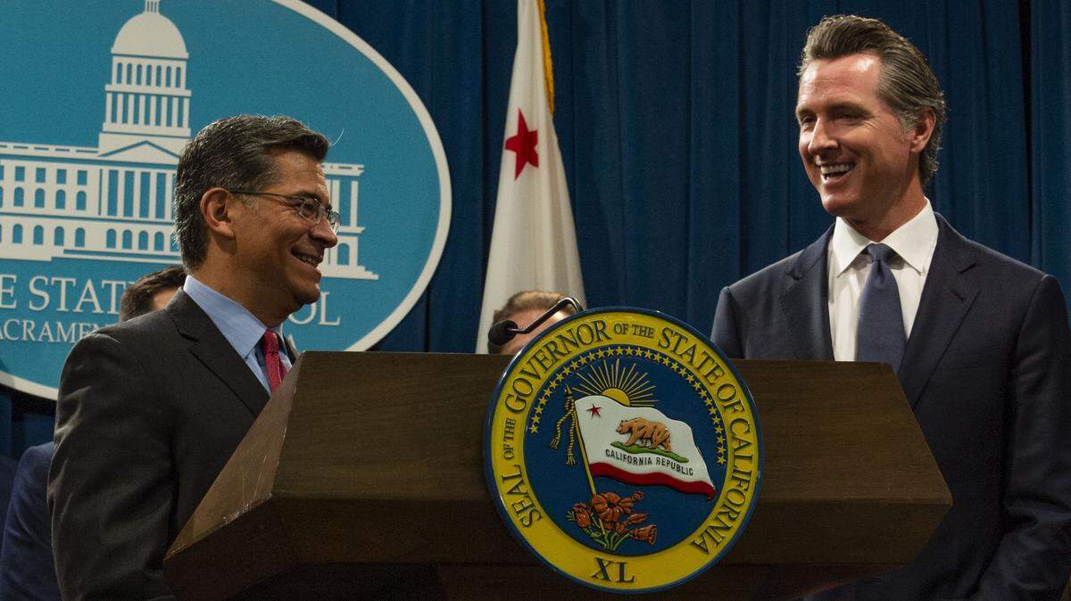 State Attorney General Xavier Becerra, left, and Gov. Gavin Newsom appear together at a press conference in August 2019, to announce a suit against the Trump administration. Newsom, who is in the final months of his tenure, declined to endorse Becerra — the frontrunner among Democratic candidates for governor — when asked about it at a public event on Friday, May 8, 2026, in San Francisco. 