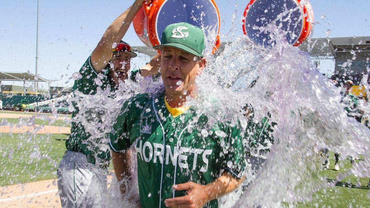 Sacramento State baseball coach Reggie Christiansen gets a shower after the Hornets won the Western Athletic Conference title Sunday.