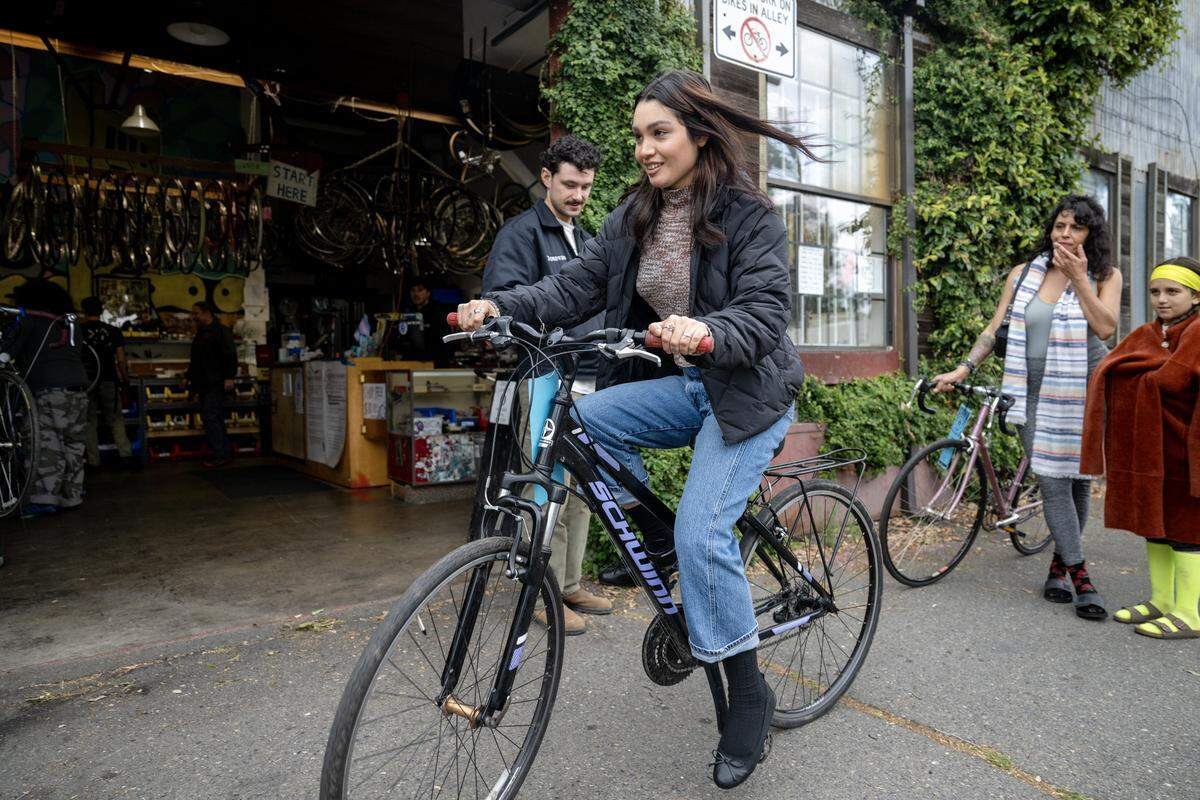 Ezzie Padilla takes a bike out for a test ride at the Sacramento Bicycle Kitchen on Tuesday.