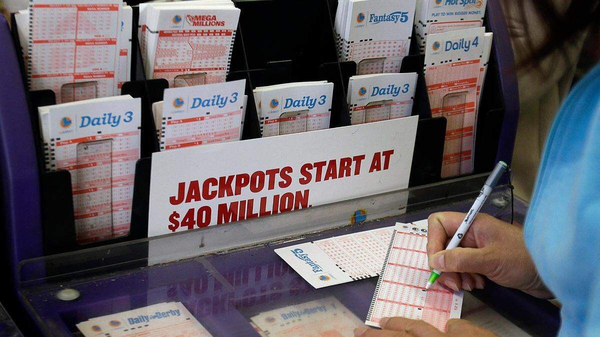 A woman prepares to choose her numbers on a lottery ticket Saturday, May 18, 2013, in the Chinatown district in Oakland, Calif. (AP Photo/Ben Margot)