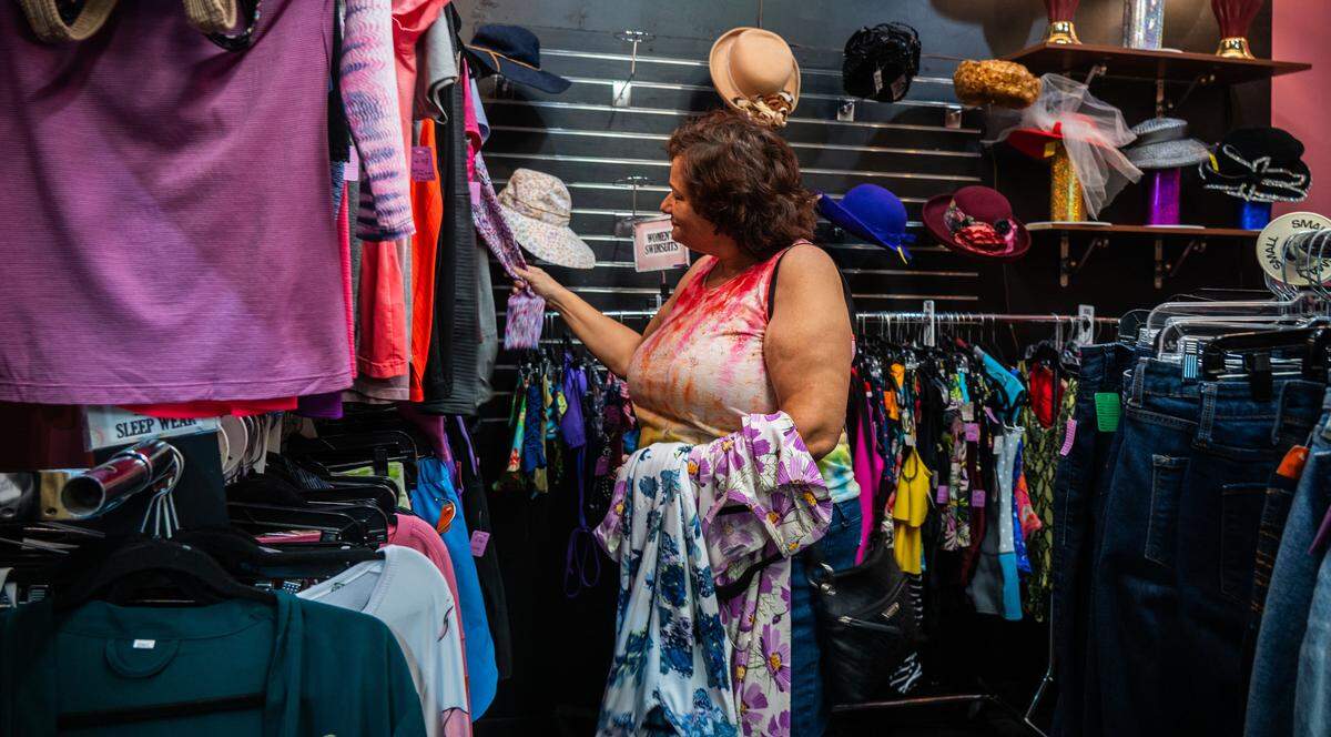 Alexis Roberts browses through the clothes at Upscale Thrift in Sacramento on Wednesday, Aug. 6, 2025.