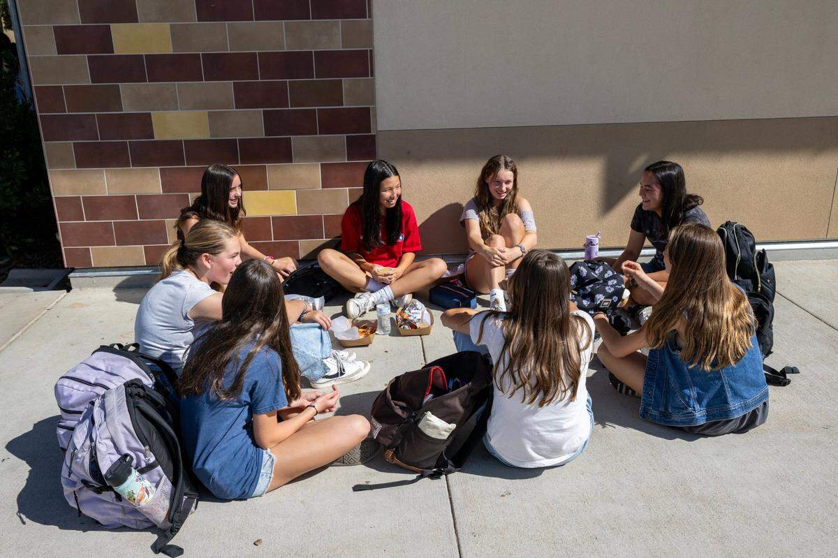 Students socialize during lunch at Sutter Middle School in Folsom on Thursday. The school has banned cell phones during school hours, including lunch, since 2022.