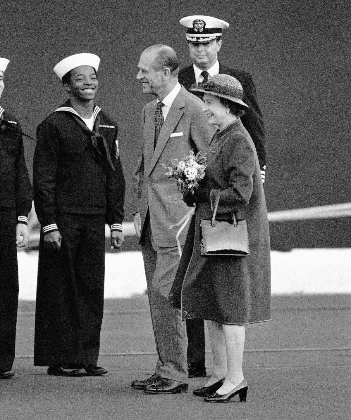 A sailor exchange smiles with Queen Elizabeth II and Prince Philip on their return to the HMS Britannia following a trip to Sacramento in afternoon on Friday, March 5, 1983 in San Francisco.. The royal couple would leave Saturday for a weekend at Yosemite National Park.