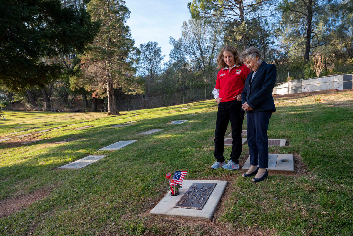 Joanne English and Lois Gruber stand near Gruber’s husband’s grave, Barney Gruber, at the Newcastle Cemetery on Wednesday. He was a marine veteran who was in the Battle of Iwo Jima in 1945. As part of Wreaths Across America Day, English hopes to place wreaths on the headstones of 1,252 veterans buried in Placer County.