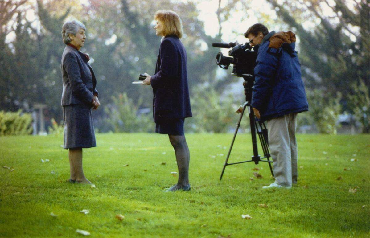 Mayor Anne Rudin faces a local television news crew as she stands on the lawn in front of City Hall in Sacramento.