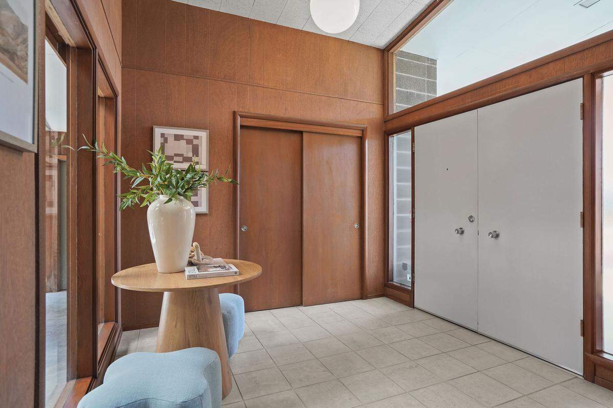 The entryway is light-filled and contains original mahogany woodwork.
