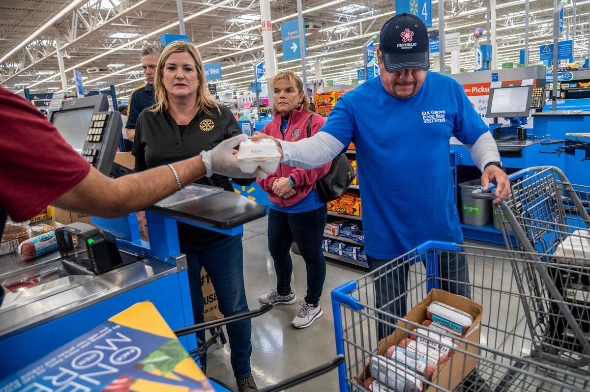Volunteers Lisa Avila, left and her husband Tim Avila, right, check out groceries inside Walmart after shopping for seniors that are sheltered in place to help stop the spread of the coronavirus in Elk Grove on Tuesday, March 24, 2020.
