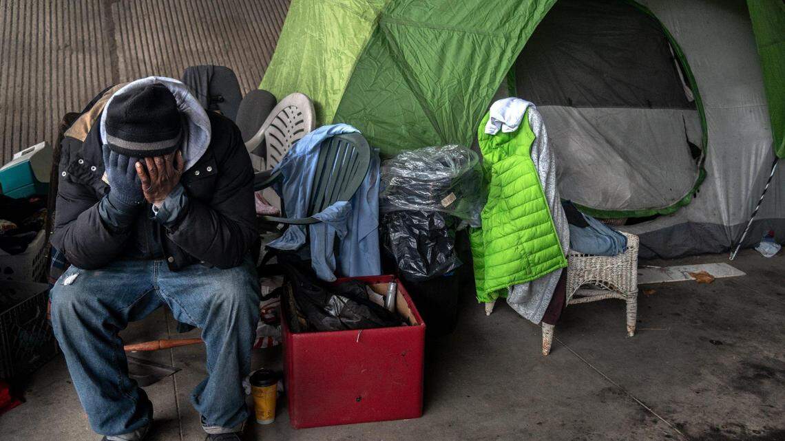 Harold Carter, 52, mourns the death of his partner Karen Hunter, 57, Thursday, Jan. 28, 2021, at the tent where she died on Tuesday night in a homeless encampment under the W-X freeway on 26th Street in Sacramento during a severe storm. “That was my wife, she was my girlfriend, she was my best friend, that was my big sister, she was everything to me,” said Carter.