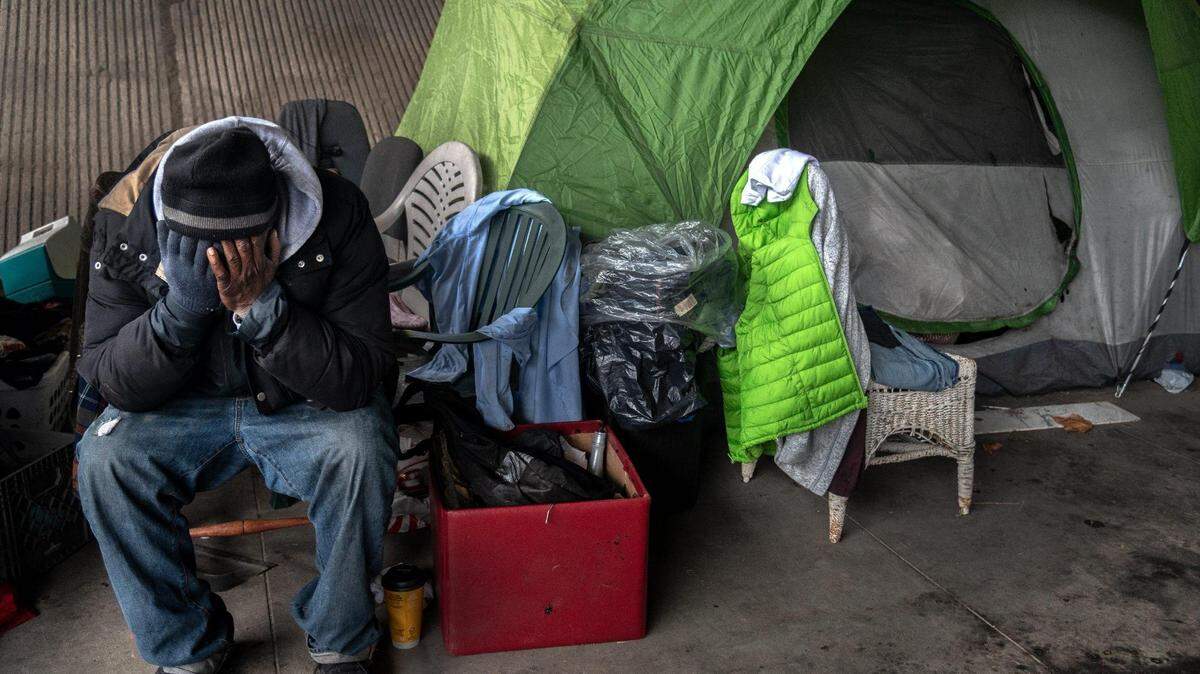 Harold Carter, 52, mourns the death of his partner Karen Hunter, 57, Thursday, Jan. 28, 2021, at the tent where she died on Tuesday night in a homeless encampment under the W-X freeway on 26th Street in Sacramento during a severe storm. “That was my wife, she was my girlfriend, she was my best friend, that was my big sister, she was everything to me,” said Carter.
