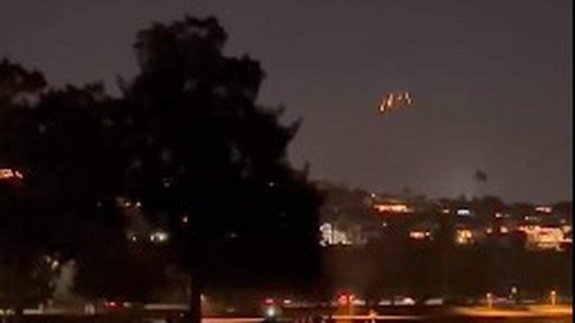 Videos of mysterious lights over San Diego were actually Navy skydivers parachuting into a soccer game, officials say.