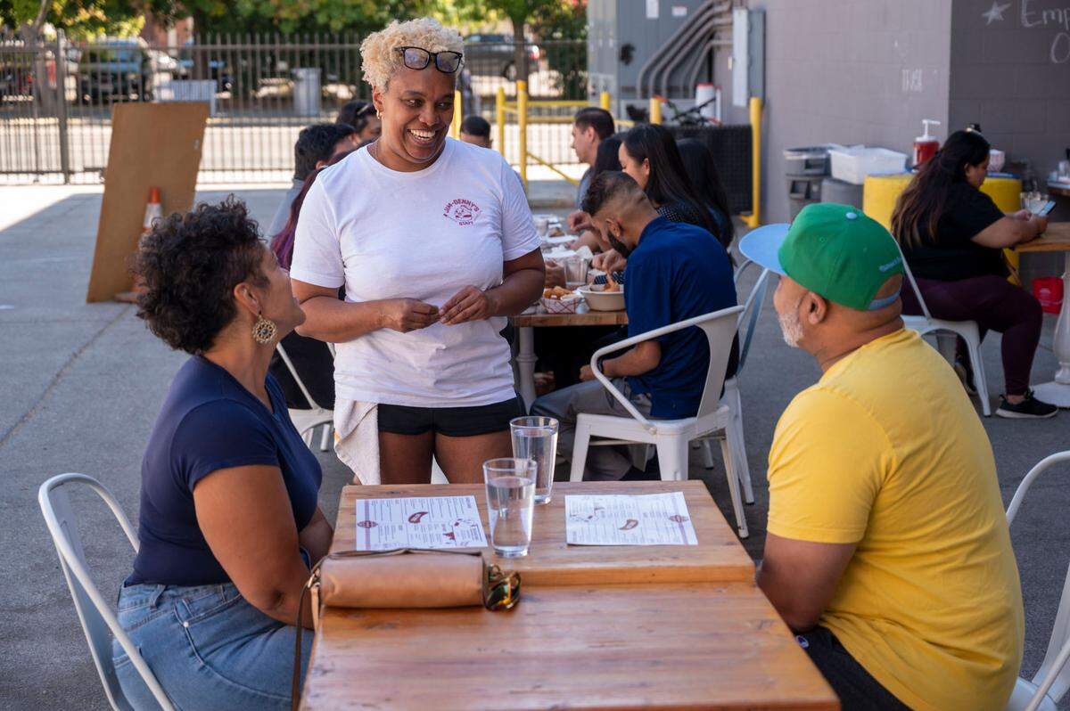 N’Gina Guyton talks with customers at Jim-Denny’s in Sacramento on Sept. 27, 2023. Guyton announced the diner would close Wednesday after she received an eviction notice from the building’s owner.