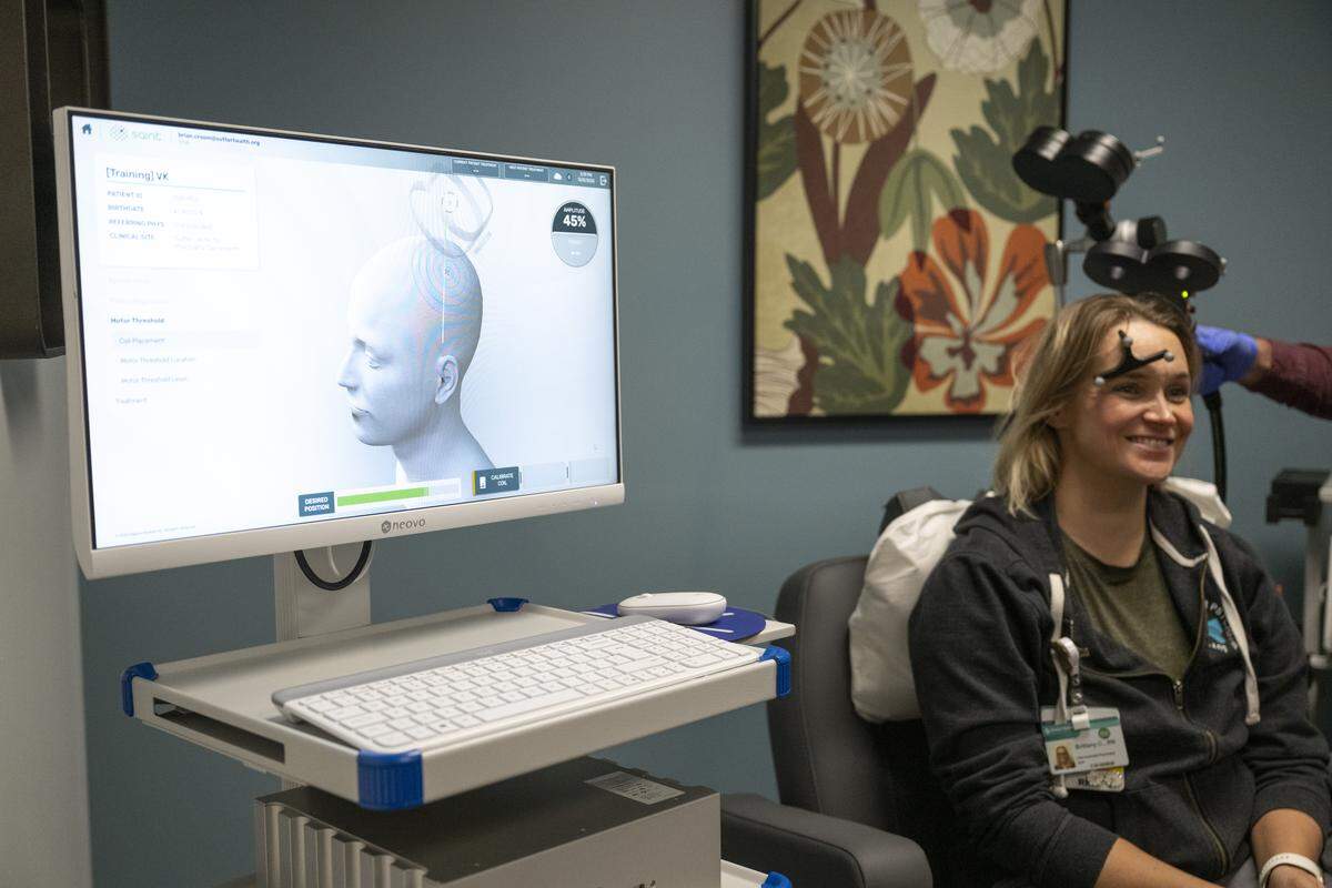Brittany Chik, a registered nurse at Sutter Center for Psychiatry, serves as a demonstration subject for the SAINT transcranial magnetic stimulation treatment at the Sutter Center for Psychiatry in Sacramento on Monday, Dec. 8, 2025.