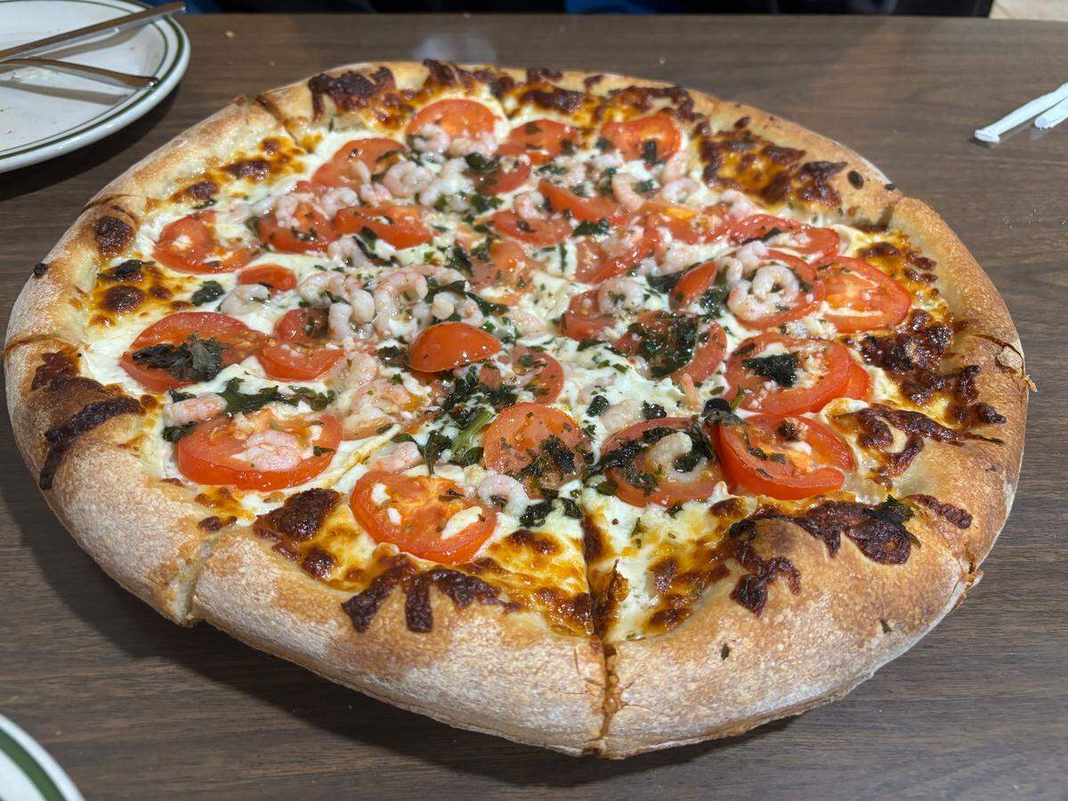 Roma’s Pizzeria in Lemon Hill offers a unique take on a margherita pizza, with baby shrimp adding a subtle umami flavor to the familiar basil and tomato pie.