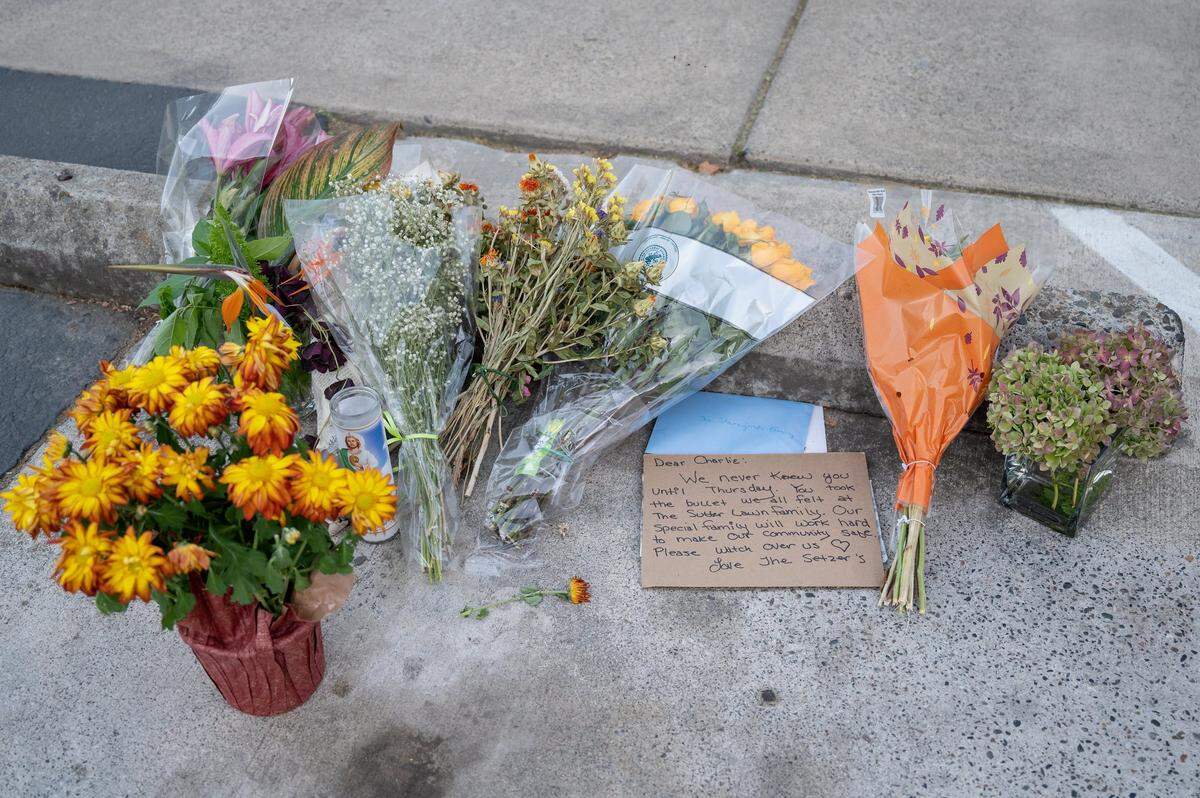 Flowers and handwritten cards rest the alley near the Sutter Lawn Tennis Club in East Sacramento on Monday, Oct. 24, 2022, close to the location of the fatal shooting of Charles Starzynski last week, before a private community meeting at the club about the incident.