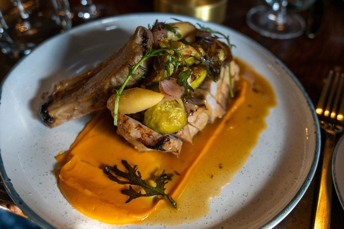 Executive chef Galice Ryan prepared a double-cut pork chop with roasted sweet potato purée, apple, Brussels sprouts and cider jus at the Star Lounge on Monday, Jan. 12, 2026, in Sacramento.