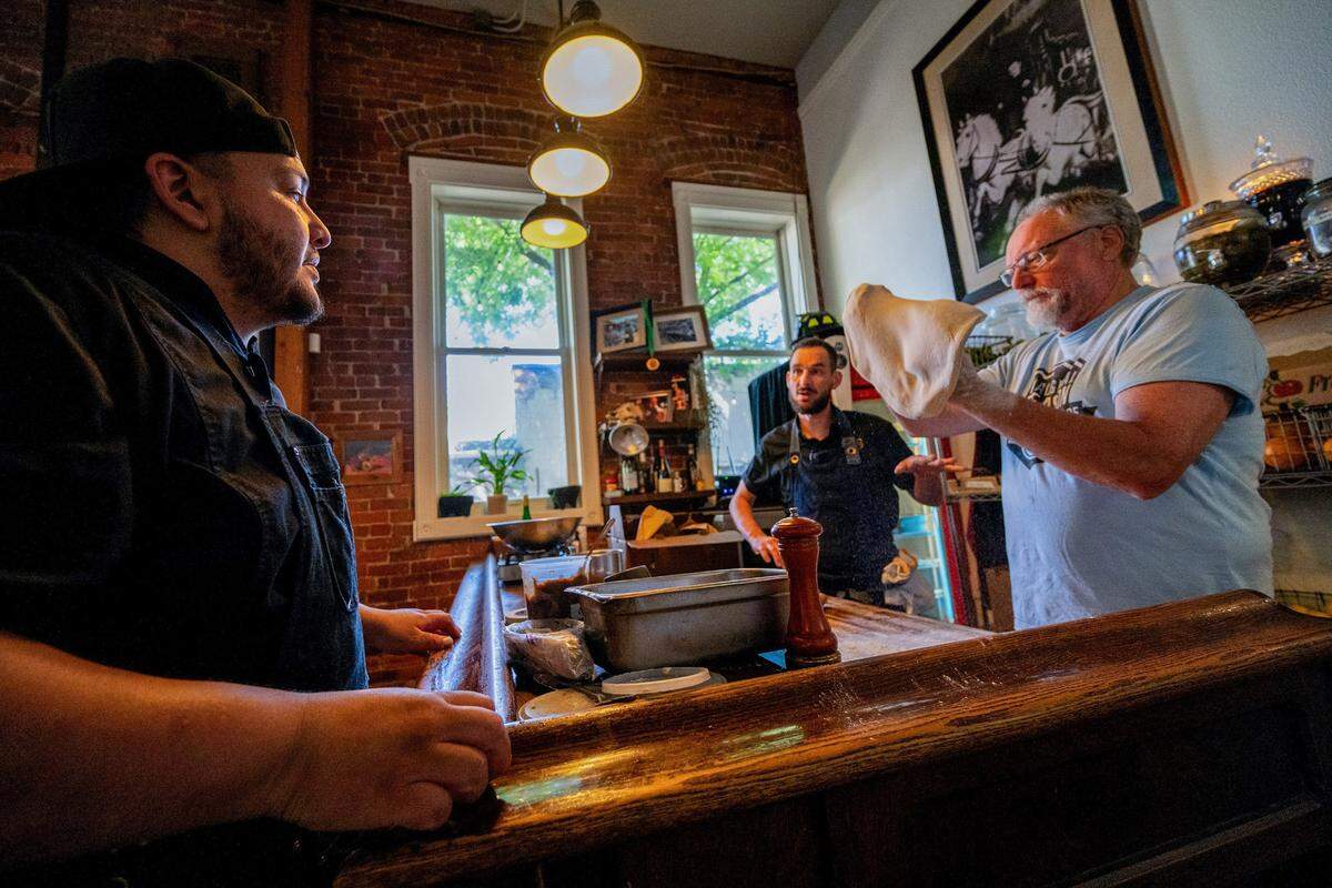 Tone Alcantara, left, a graduate of the Reintegration Academy, listens to instructions from Mulvaney’s B&L executive chef John Trujillo as head chef and owner Patrick Mulvaney prepares pizza dough on May 27 at the midtown Sacramento restaurant. Alcantara said he is very grateful to work there. “Nobody sees me as the ex-con – they see me as someone who works hard, who’s a good person – and it’s kind of a safe haven for me,” he said.