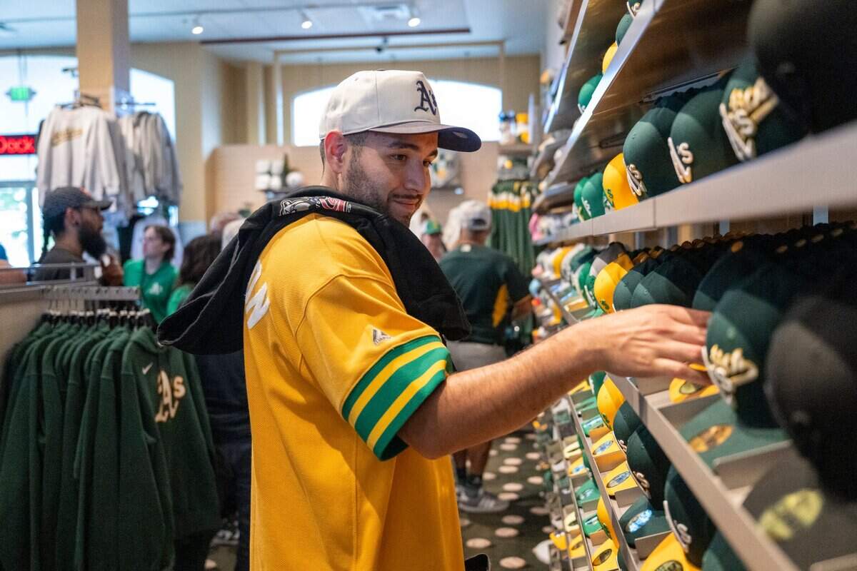 Christian Lopez looks through the Athletics team store before the team plays the San Fransisco Giants at Sutter Health Park on Independence Day.