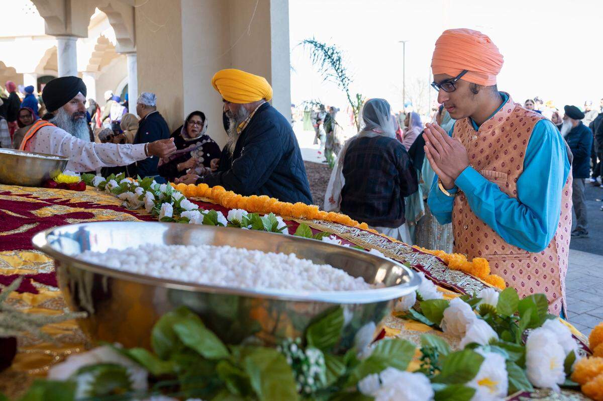 Roseville resident Bhavnoor Singh, 17, says a prayer at the float with the Holy Scripture before the Sacramento Sikh Society’s first Nagar Kirtan parade on Sunday, March 26, 2023, at the society’s temple in Vineyard.