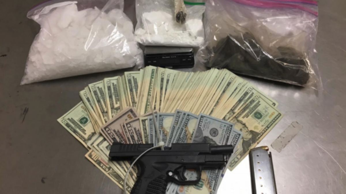 Probation officers made two arrests while serving search warrants Tuesday and seized pounds of drugs, a .45-caliber pistol and more than $7,000.