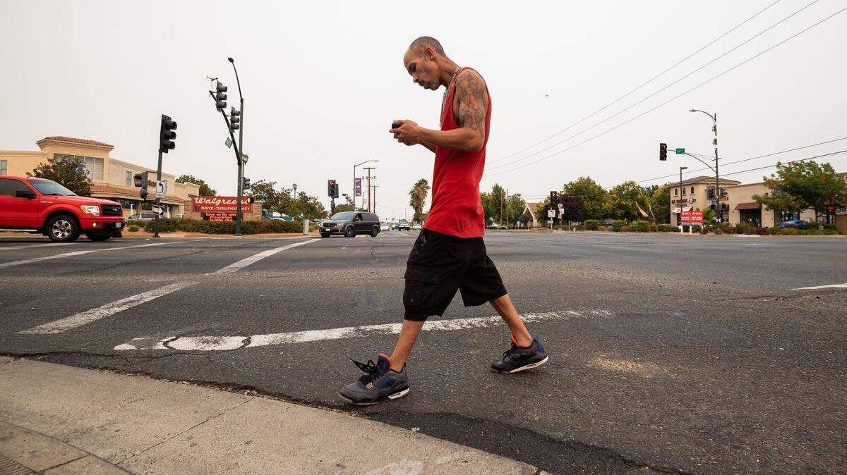 Marcos Alexander Colon, of south Sacramento, crosses Florin Road at 24th Street on Thursday, Aug. 19, 2021, in Sacramento. “I walk past this intersection all the time, and yeah it’s crazy. People don’t stop, people don’t wait for other people when it’s their turn or anything like that, collisions,” he said.