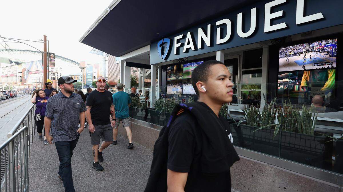 Fans walk past a Fanduel sports betting location at Footprint Center before Game Five of the Western Conference First Round NBA Playoffs between the Phoenix Suns and the New Orleans Pelicans on April 26, 2022, in Phoenix. 