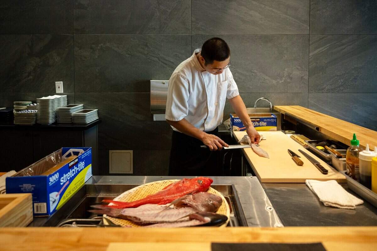 Chef Jun fillets fresh fish at Chef Frank Japanese Cuisine in North Natomas last month.