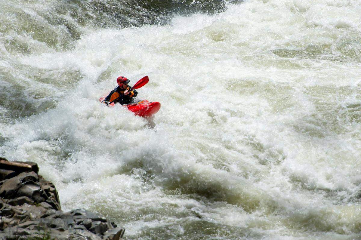 A kayaker traverses the Class III-plus Troublemaker rapid Sunday, May 21, 2023, on the south fork of the American River in Coloma.