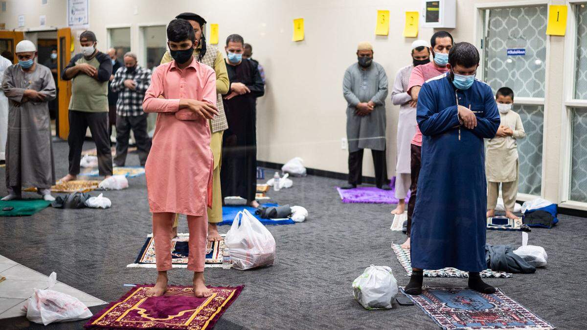 Worshippers wearing masks and socially distanced inside south Sacramentos Masjid Annur Islamic Center gather for Taraweeh prayers Tuesday, April 13, 2021, after the first day of fasting for Muslims during Ramadan. Muslims fast during the holy month from dawn to sunset then often break fast together.