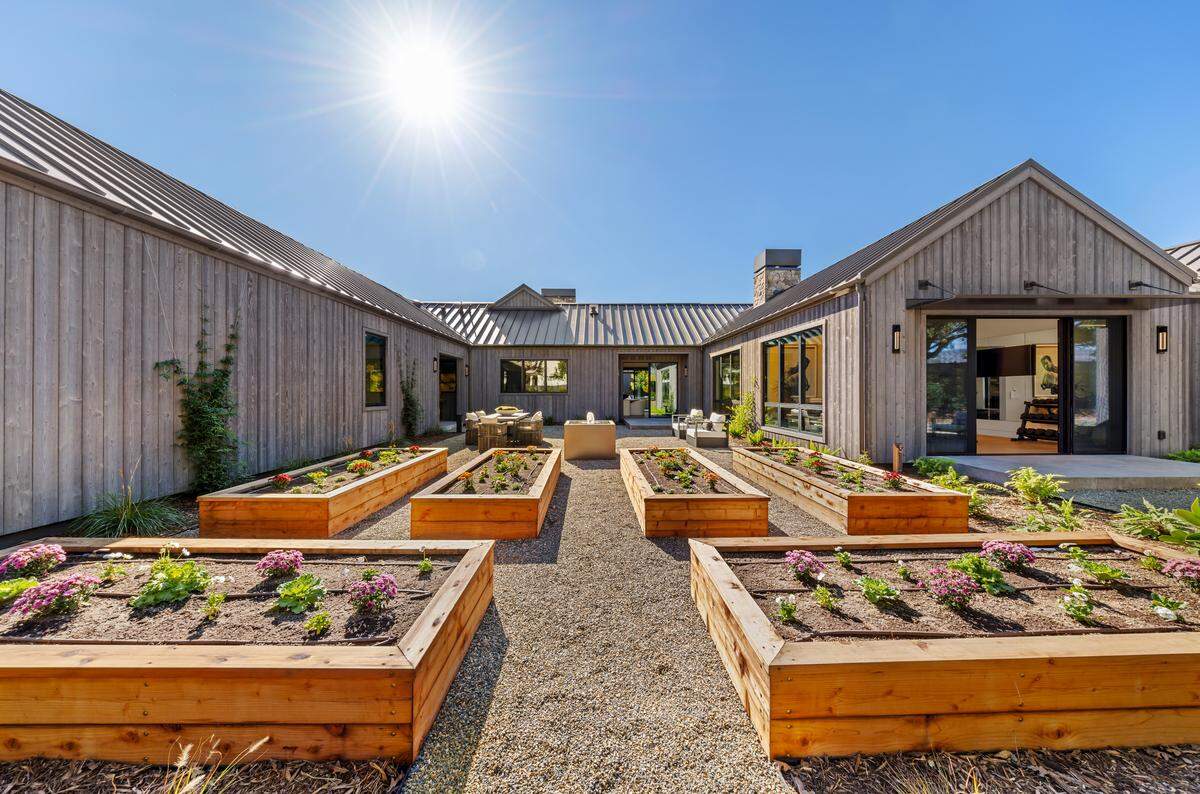 The five-acre estate has expansive lawns and culinary beds for farm-to-table living.