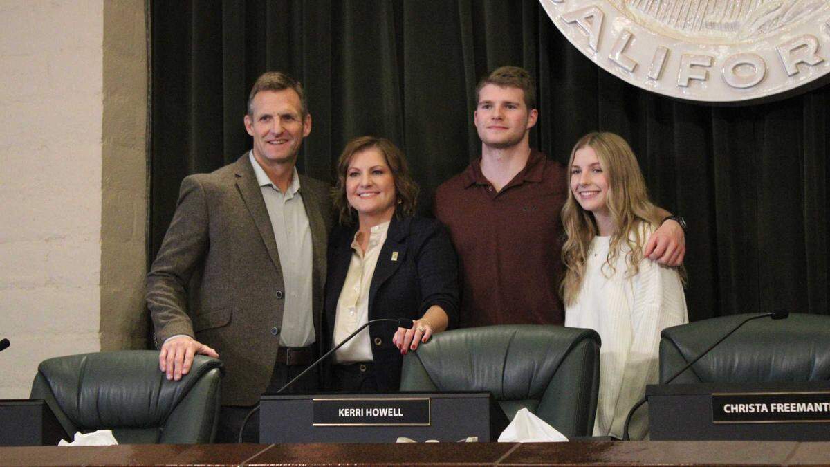 Folsom District 5 council member Anna Rohrbough (second from left) poses with her family next to former Mayor Kerri Howell’s vacated seat shortly after swearing in at a special city council meeting on Monday, Dec. 12. Rohrbough beat Howell by 266 votes in the city’s first election based on geographic districts.