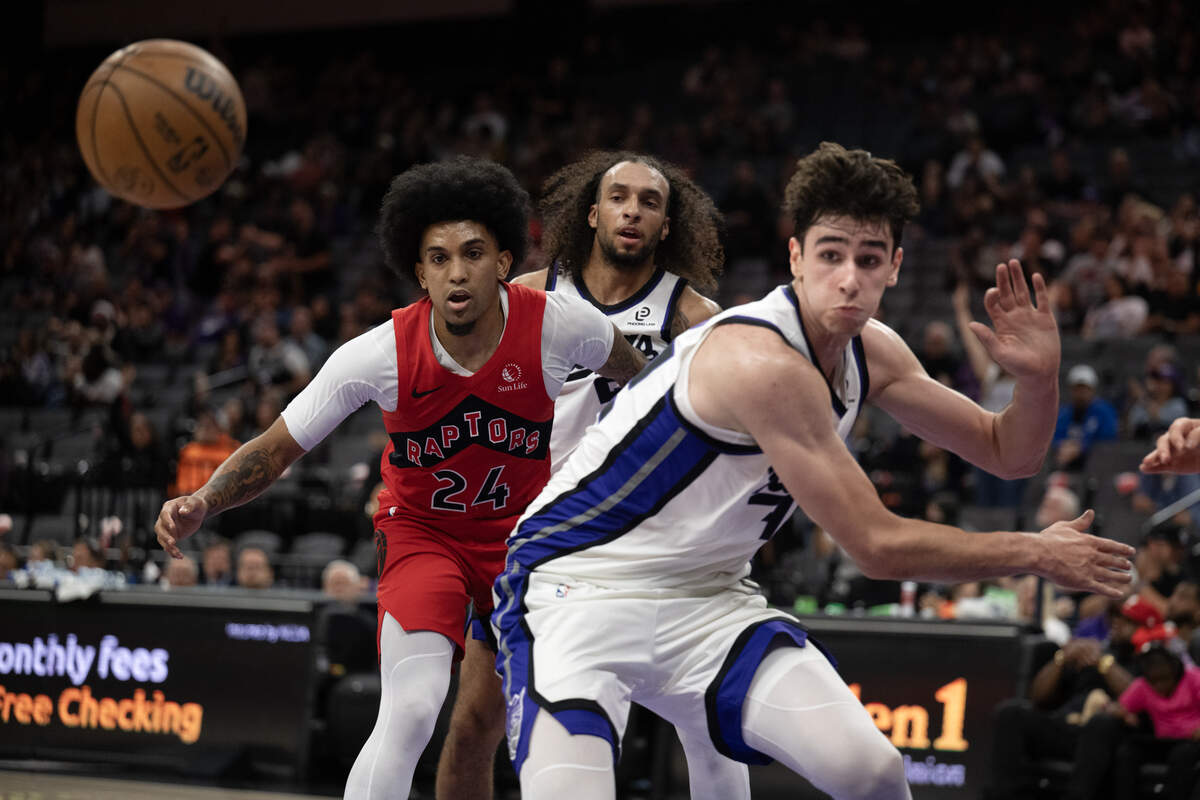Sacramento Kings center Maxime Raynaud, right, and Toronto Raptors guard Chucky Hepburn (24) watch a loose ball fly by in the second half on Wednesday, Oct. 8, 2025, at Golden 1 Center in Sacramento.