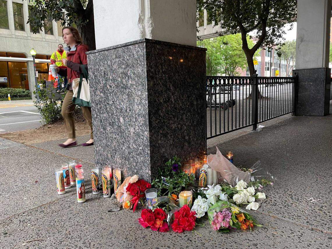 Flowers and candles are seen Monday, April 4, 2022, at a small memorial at 10th and L streets for the victims of a mass shooting in downtown Sacramento the night before. Six people were killed and 12 others were wounded in the attack.