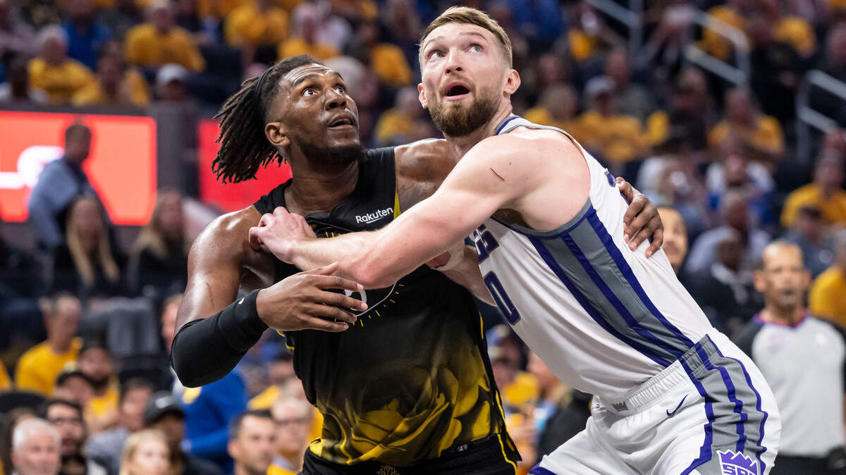 Sacramento Kings center Domantas Sabonis (10), right, and Golden State Warriors center/forward Kevon Looney (5) vie for a rebound, which is not needed after a basket from Golden State Warriors guard Stephen Curry (30), during the second half of Game 3 of the first-round NBA playoff series at Chase Center in San Francisco on Thursday, April 20, 2023.