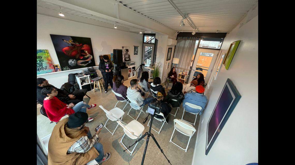 A small crowd gathers to listen to an interview on Sunday Morning Vibes
