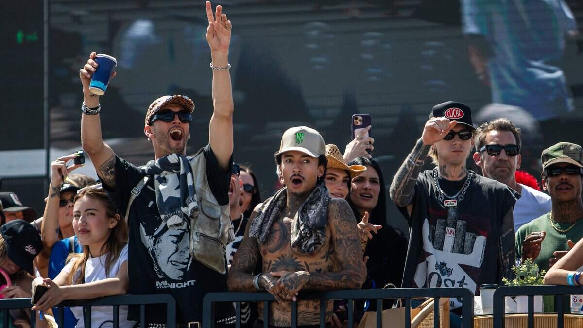 US skateboarder Nyjah Huston (C) watches from a VIP area after been injured during session before the the Santa Monica Takeover stop of the 2025 Street League Skateboarding (SLS) Championship Tour at the Santa Monica Pier in California, on May 23, 2025. (Photo by Apu GOMES / AFP) (Photo by APU GOMES/AFP via Getty Images)