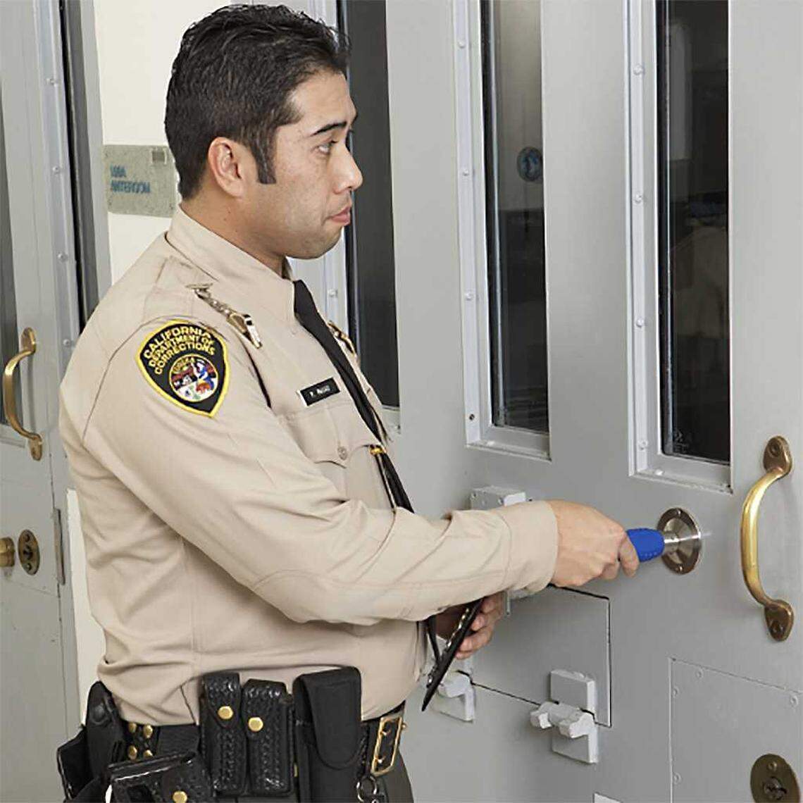 An image used for promotional purposes on the Guard1 website illustrates a California correctional officer using the Guard1 Pipe II monitoring device.