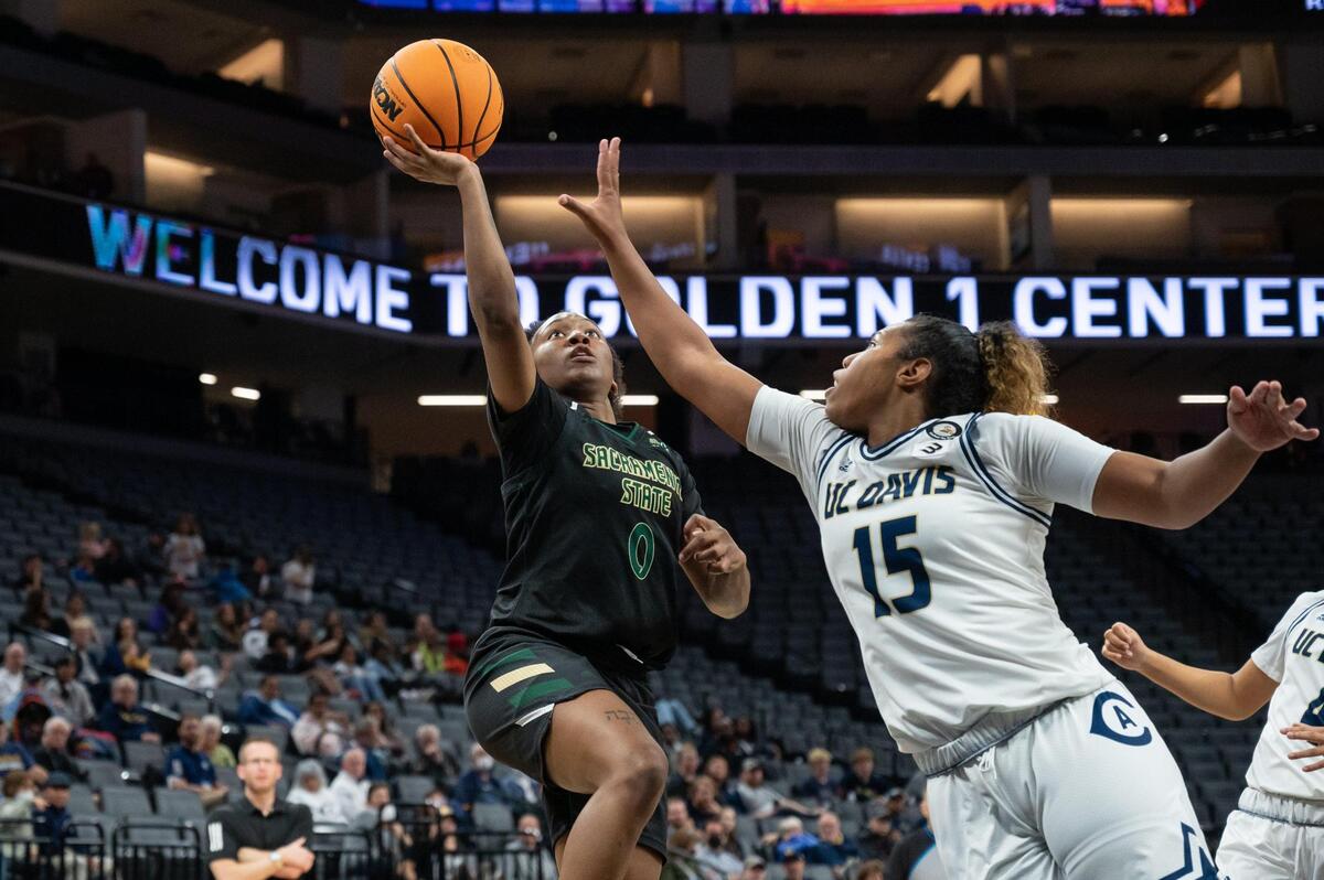 Sacramento State Hornets guard Kahlaijah Dean (0) makes and layup and draws the foul from UC Davis Aggies guard Evanne Turner (15) and makes the free throws during the fourth quarter in the Causeway Classic on Tuesday, Nov. 22, 2022, at Golden 1 Center in Sacramento. Dean had a double-double with 12 points and 11 rebounds. The Hornets won 67-45.