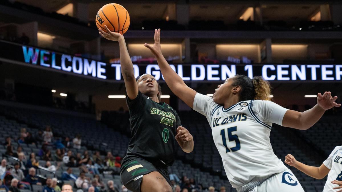 Sacramento State Hornets guard Kahlaijah Dean (0) makes and layup and draws the foul from UC Davis Aggies guard Evanne Turner (15) and makes the free throws during the fourth quarter in the Causeway Classic on Tuesday at Golden 1 Center in Sacramento. Dean had a double-double with 12 points and 11 rebounds. The Hornets won 67-45.