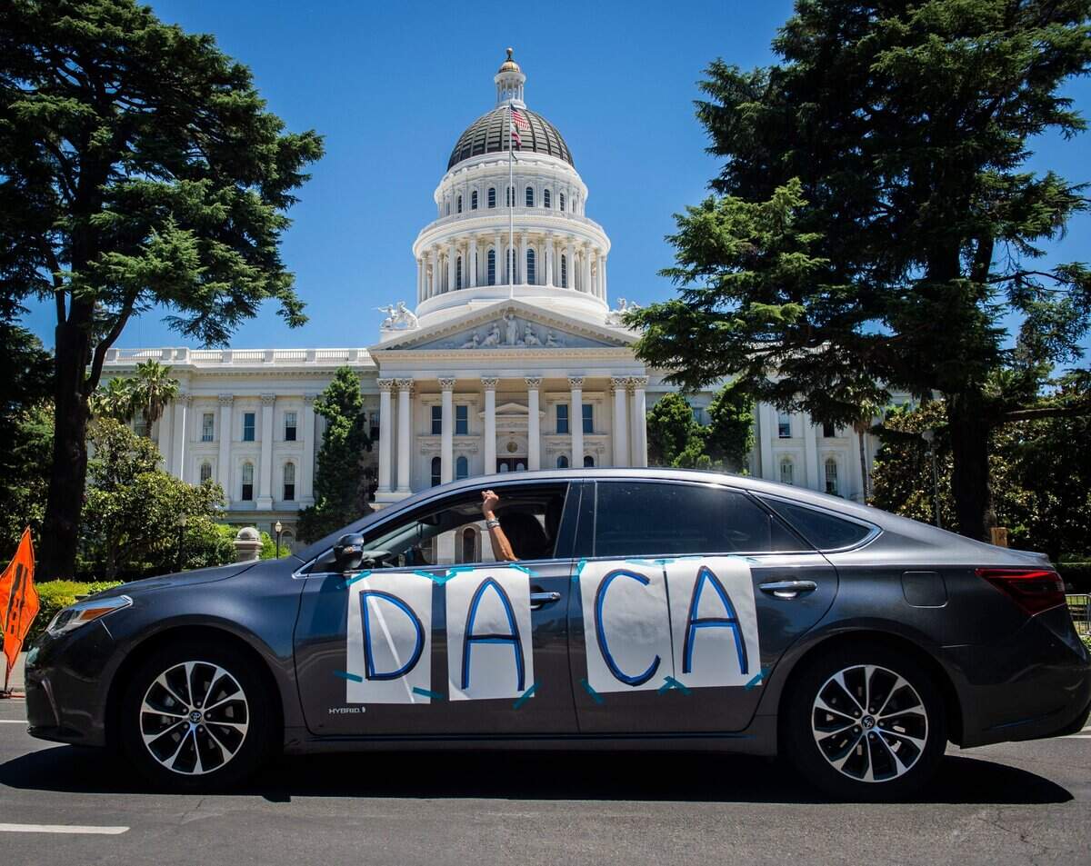 18. A driver in a DACA car rally honks and raises a fist in front of the state Capitol in downtown Sacramento on Thursday, June 18, 2020, to celebrate the U.S. Supreme Court’s decision to block the Trump administration’s plan to terminate the Deferred Action for Childhood Arrivals program.