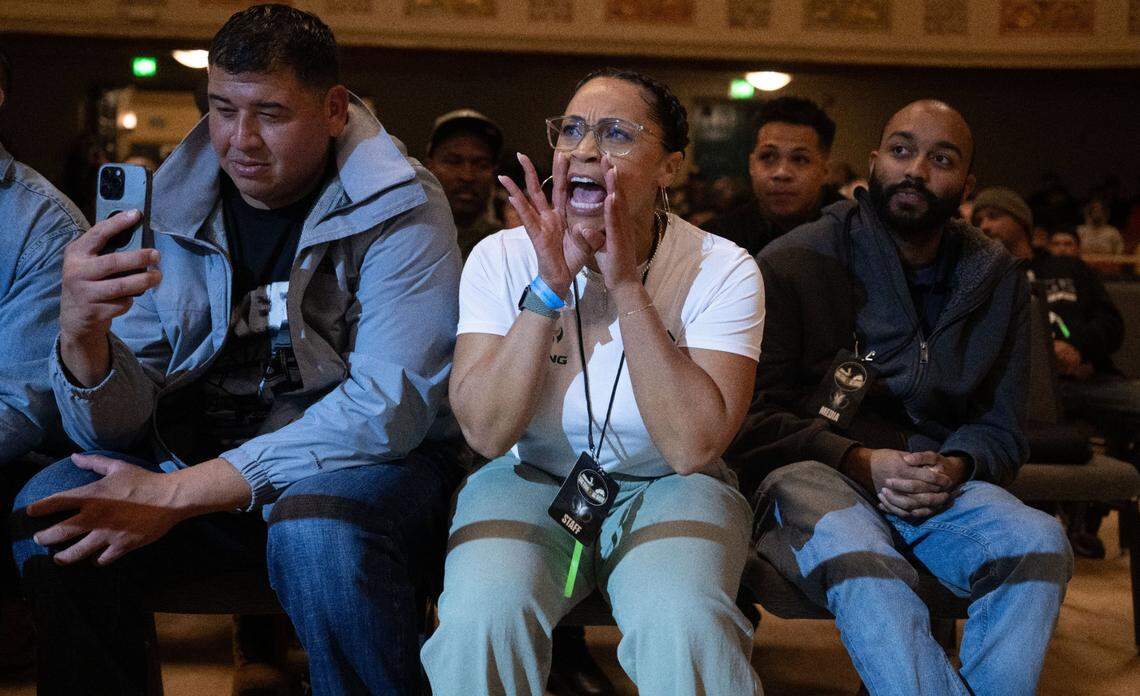 Janelle Gonzales cheers on her daughter Ayahna as she boxes for Sacramento State during the Causeway Boxing Classic at Sacramento’s Memorial Auditorium on Friday.