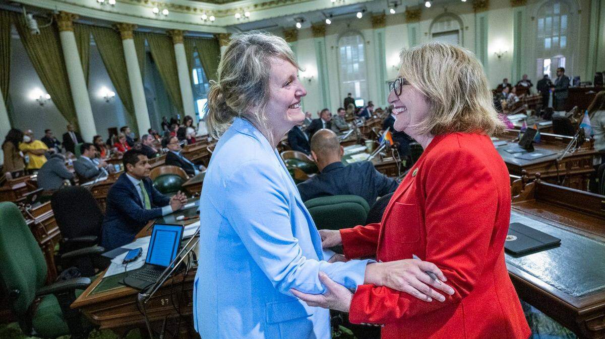 Assemblywoman Buffy Wicks, D-Oakland, on Thursday, June 1, 2023, celebrates the passing of her bill, the California Journalism Preservation Act, with Assemblywoman Eloise Gómez Reyes, D-Colton. The bill, AB 886, would require companies like Meta and Google to pay a percentage of their advertising revenue as a “journalism usage fee” to news organizations producing content that is shared on their platforms.