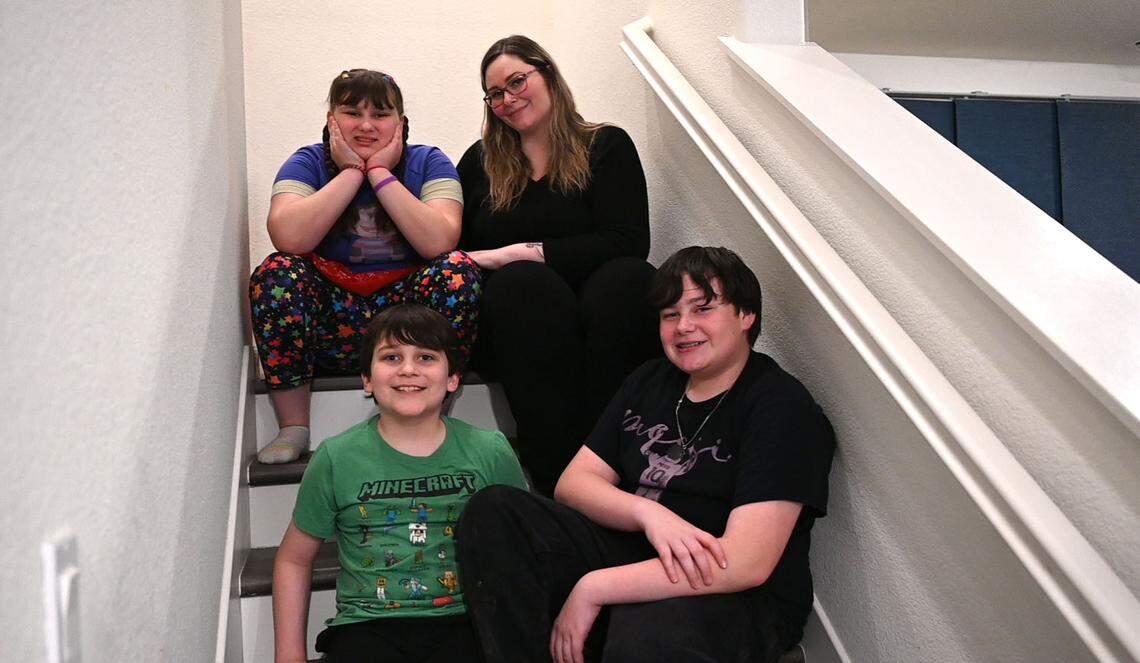 Meagen Reveles Kuntz sits with her three children at their home in Woodland on Tuesday. She’s been battling Woodland Joint Unified School District to provide the special ed services outlined in her daughter’s individualized educational plan.