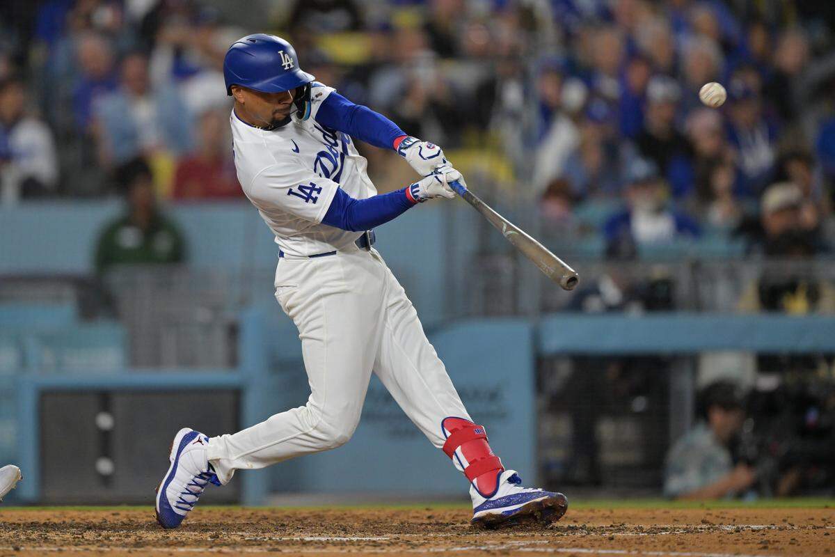Mookie Betts of the Los Angeles Dodgers hits a three-run home run in the sixth inning against the Colorado Rockies at Dodger Stadium on Wednesday. Betts recently deleted social media apps off his phone due to hate he was receiving.