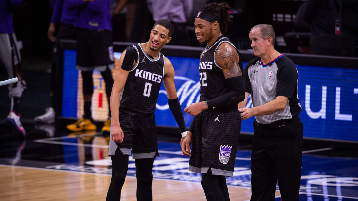 Sacramento Kings guard Tyrese Haliburton (0), left, and Sacramento Kings center Richaun Holmes (22) talk after a timeout during the fourth period against the Denver Nuggets at the NBA game Saturday, Feb. 6, 2021, at Golden 1 Center in Sacramento. The Kings beat the Nuggets 119-114.