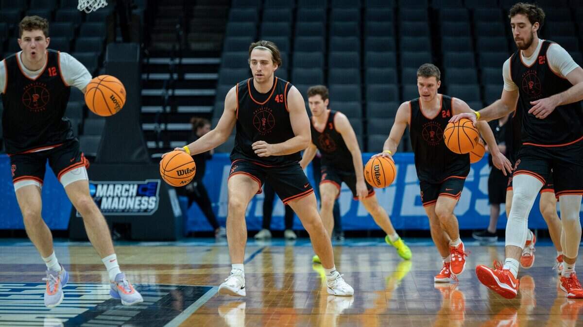 Princeton Tigers’ Caden Pierce (12), Philip Byriel (43), Blake Peters (24) and Jacob O’Connell (25) warm up during practice for the NCAA Mens’s Tournament Golden 1 Center in Sacramento on Wednesday.