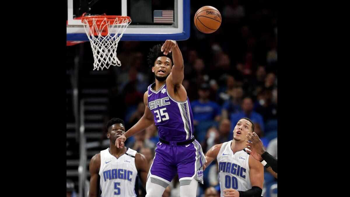 Sacramento Kings rookie Marvin Bagley III (35) leaps for a loose ball between Orlando’s Mohamed Bamba (5) and Aaron Gordon (00) in the first half Tuesday night, Oct. 30, 2018, in Orlando, Fla. Bagley had 10 points and nine rebounds in the Kings’ fourth consecutive win.