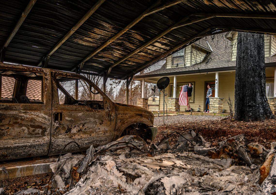 Sean and Dawn Herr collect an American flag that survived the Camp Fire along with their Paradise home during a March visit to the property. Gov. Gavin Newsom praised a McClatchy story explaining how homes built after 2008 to tougher building codes, like the Herrs’, were more likely to survive the fire.
